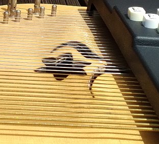 The face of this OS45E has warped and partially delaminated as a result of the frame being carved into to make room for the battery/EQ module. Other models with the same pickup technology suffered the same fate. The damage is irreparable.  Click for bigger photo.