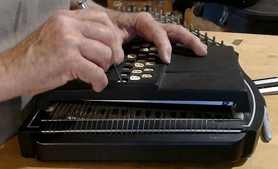 Because the chord name buttons slide around, you'll have to nudge most of them back into place when replacing the chord bar cover.  Click for a bigger photo.