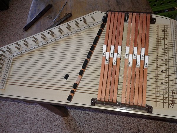 A late '60s Sears Silvertone-branded Autoharp with a loose felt piece.  Click for bigger picture