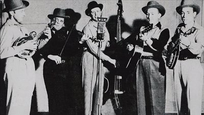 Bill Monroe (on the left) and the Bluegrass Boys.  Scruggs is on the right.