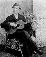 A mid-to-late 19th century phto of a young man with his guitar. Click for bigger picture.