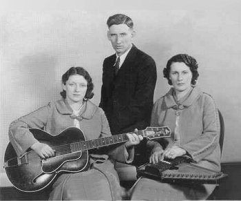 The Carter Family as they recorded and broadcast, Maybelle on guitar, AP in the back, and Sarah on the Autoharp.